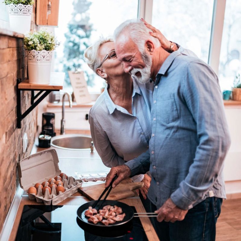 Elderly couple preparing a meal.